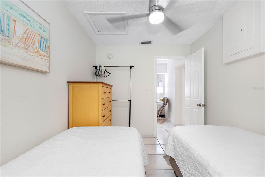 614 Gulf Boulevard, Unit 9 Indian Rocks Beach, FL 33785 - Photo 31 of 41 a bedroom with a bed and a chandelier