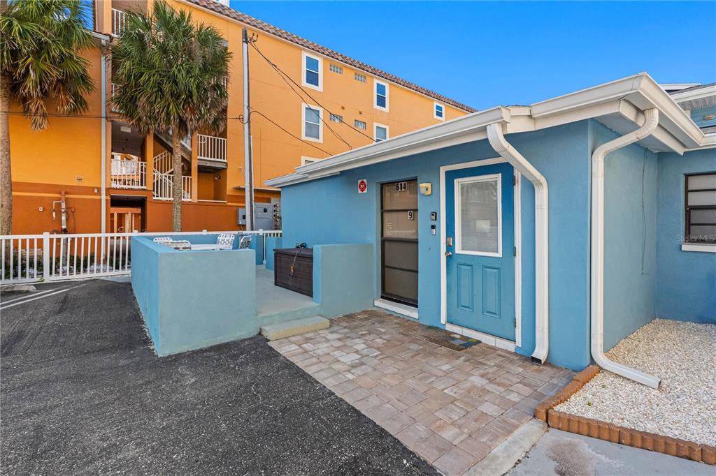 614 Gulf Boulevard, Unit 9 Indian Rocks Beach, FL 33785 - Photo 8 of 41 a backyard of a house with oven and wooden fence