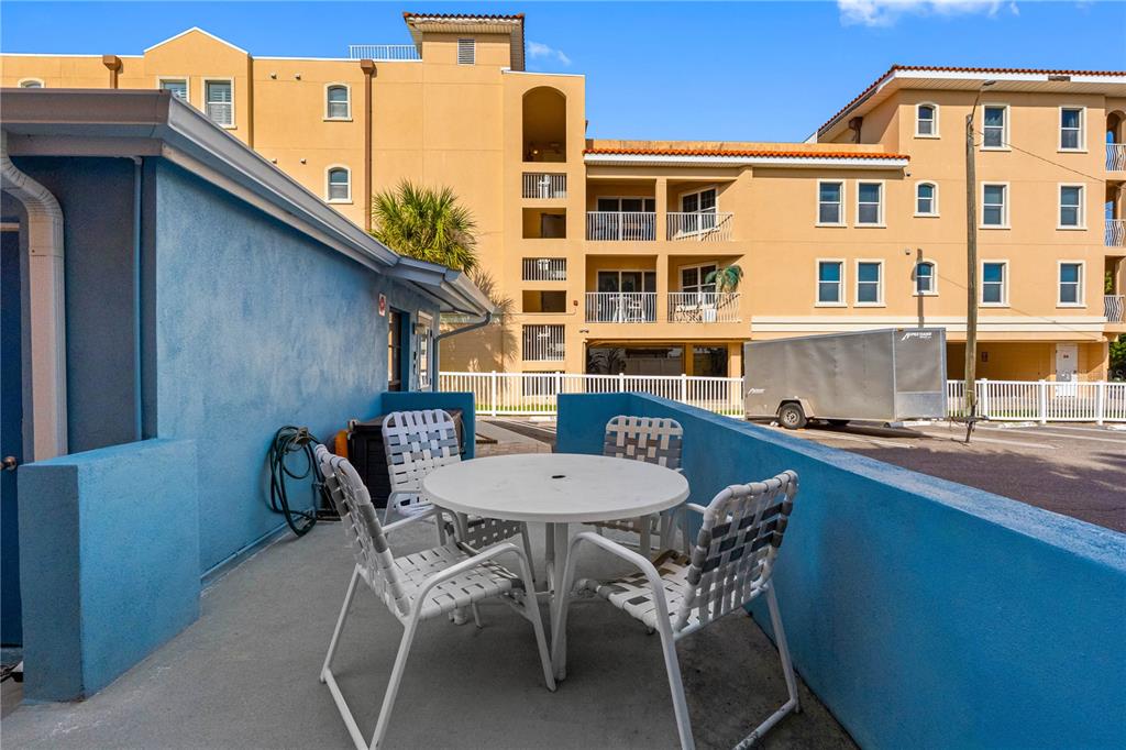 614 Gulf Boulevard, Unit 9 Indian Rocks Beach, FL 33785 - Photo 10 of 41 a view of a table and chairs in patio