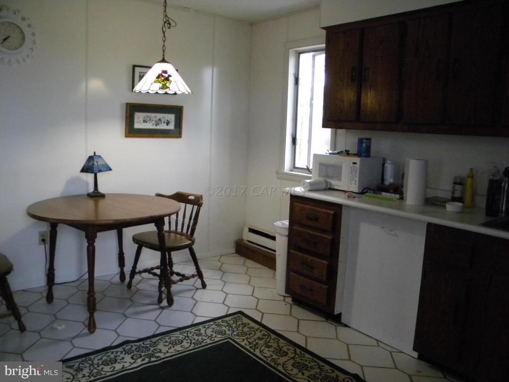 3951 Tyler Road Ewell, MD 21824 - Photo 6 of 17 a view of kitchen island with stainless steel appliances granite countertop a stove a sink and a microwave