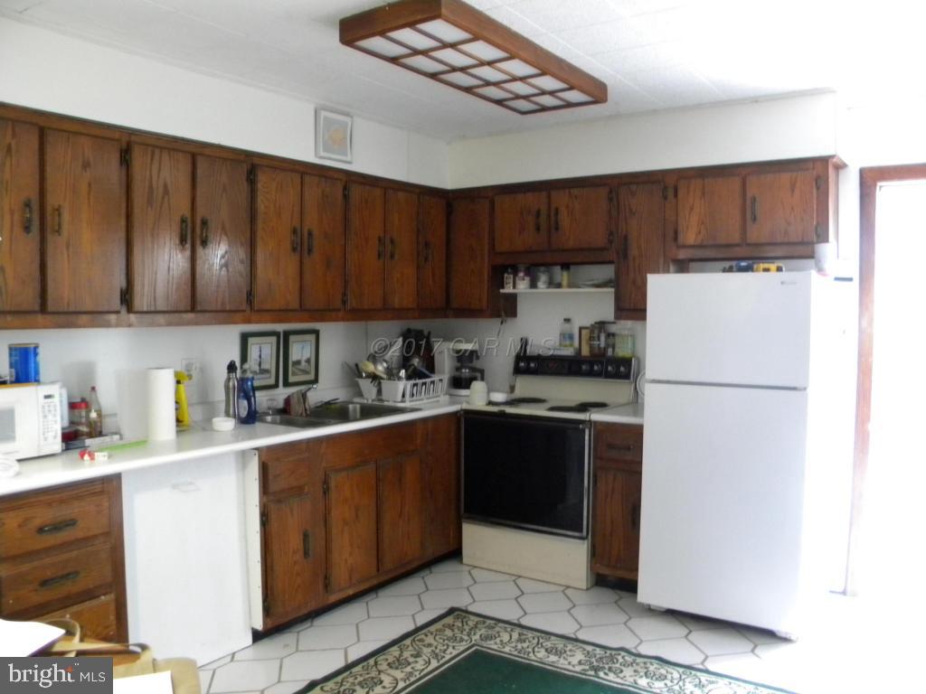 3951 Tyler Road Ewell, MD 21824 - Photo 7 of 17 a kitchen with a refrigerator sink and cabinets