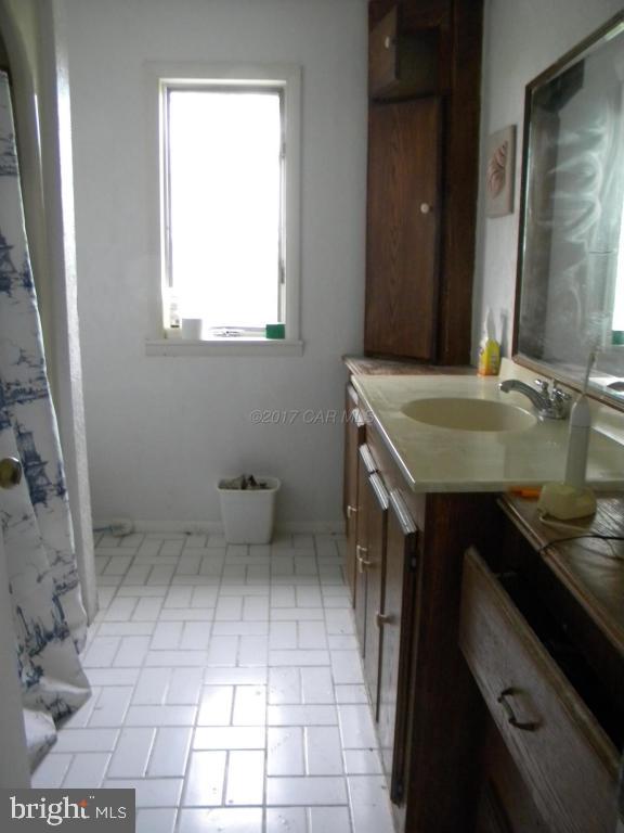 3951 Tyler Road Ewell, MD 21824 - Photo 8 of 17 a bathroom with a sink and a toilet