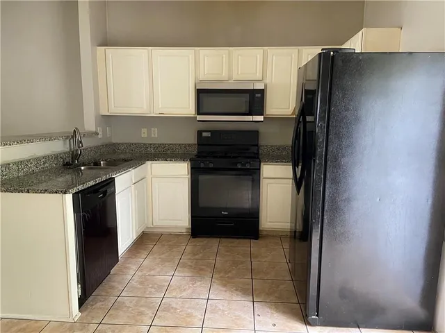 a kitchen with a refrigerator stove and a sink