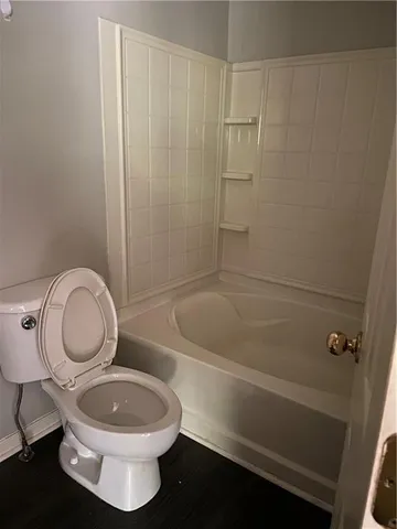 a bathroom with a toilet a sink and bathtub