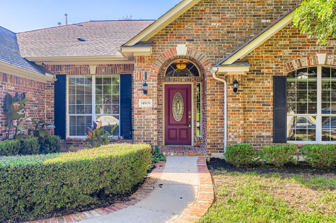 14909 Solera Drive Austin, TX 78717 - Photo 1 of 1 Doorway to property featuring brick siding and a shingled roof