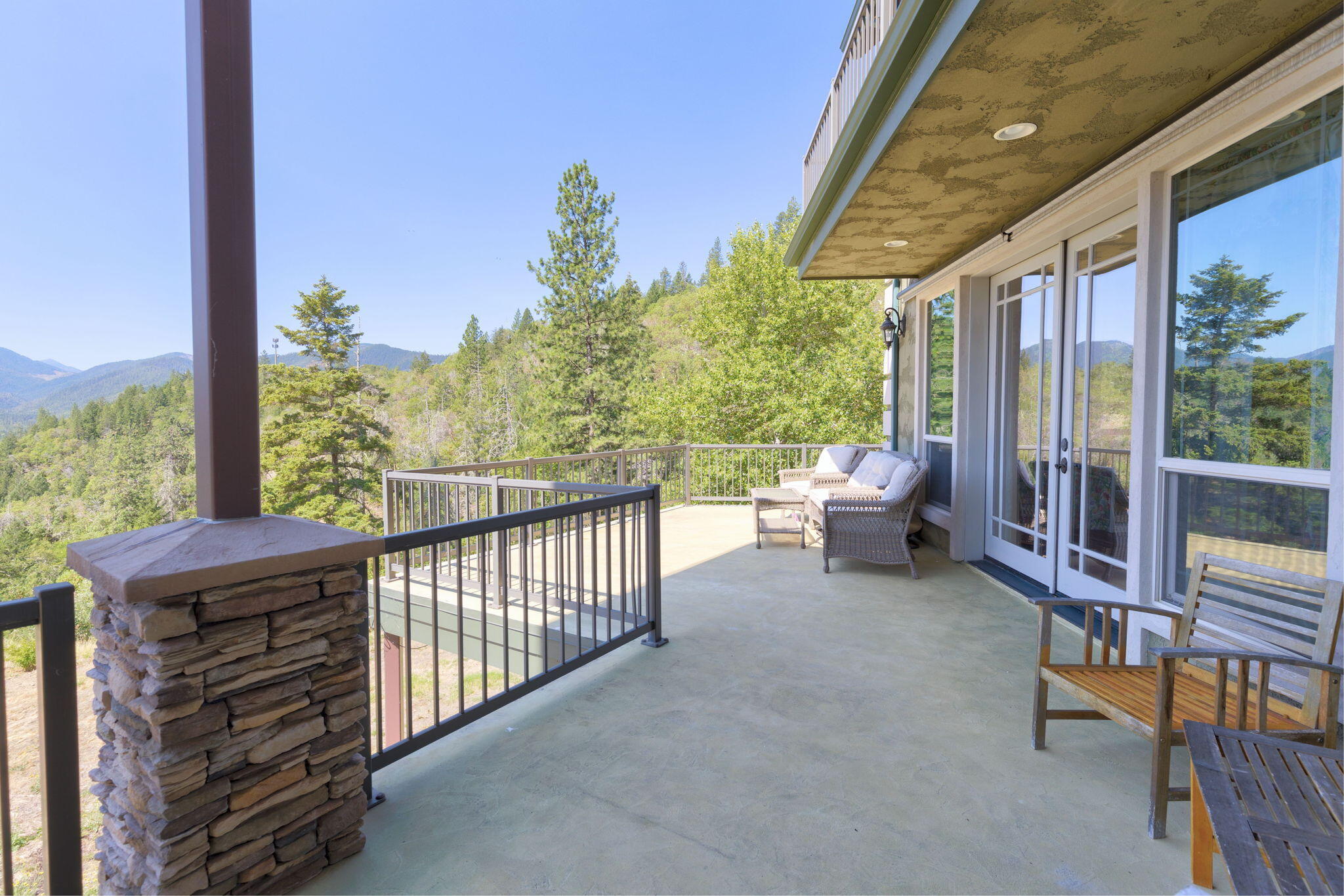 7304 North Applegate Road Grants Pass, OR 97527 - Photo 69 of 87 a view of a porch with furniture and floor to ceiling window