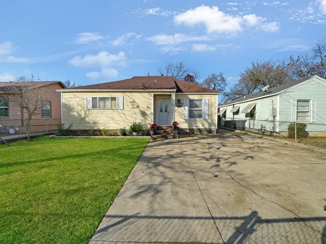 a view of house with yard and green space