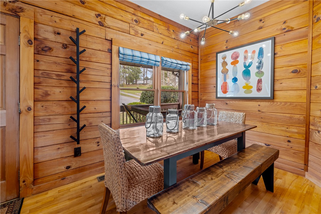 203 Little Lane Seneca, SC 29672 - Photo 13 of 48 This inviting dining area features warm wood paneling and a luminous fixture, perfect for gatherings.
