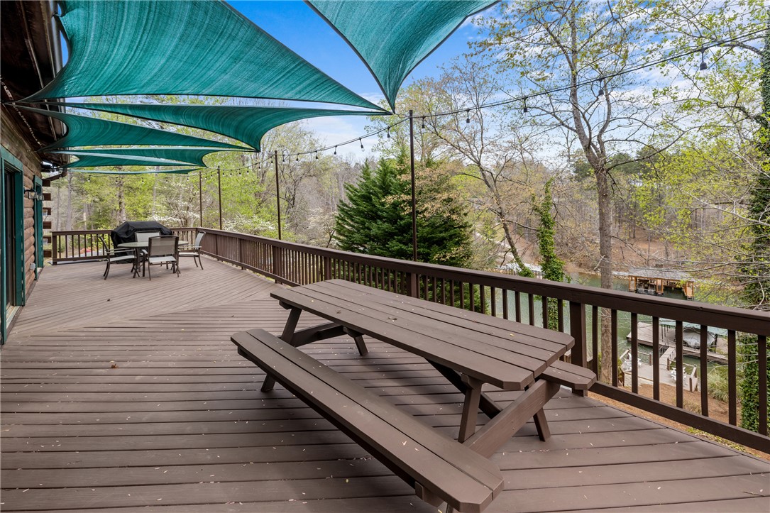 203 Little Lane Seneca, SC 29672 - Photo 18 of 48 This spacious deck overlooks a serene lake, perfect for outdoor dining and relaxation.