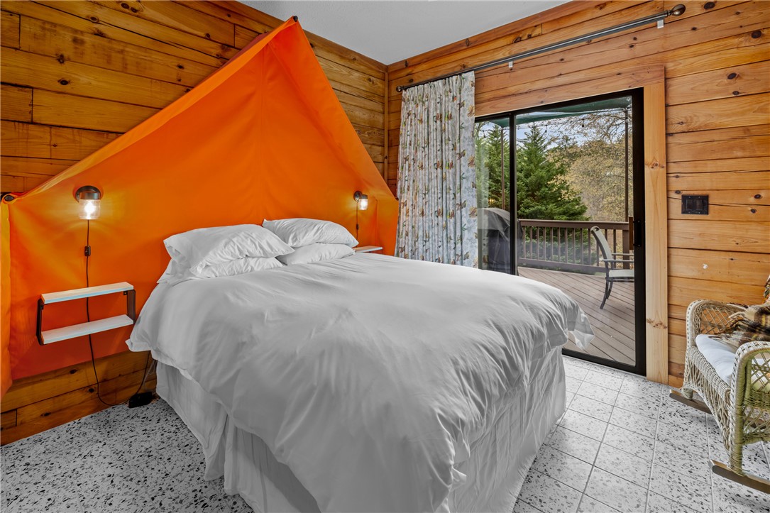 203 Little Lane Seneca, SC 29672 - Photo 20 of 48 This cozy bedroom features a private deck, offering a peaceful retreat with natural views.