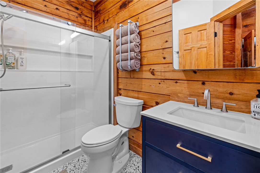 203 Little Lane Seneca, SC 29672 - Photo 21 of 48 This bathroom boasts stylish wood walls, a sleek modern vanity, and a refreshing shower.