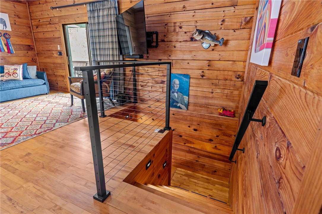 203 Little Lane Seneca, SC 29672 - Photo 25 of 48 Warm wood tones define this inviting interior, featuring durable hardwood flooring and a stylish cable railing.