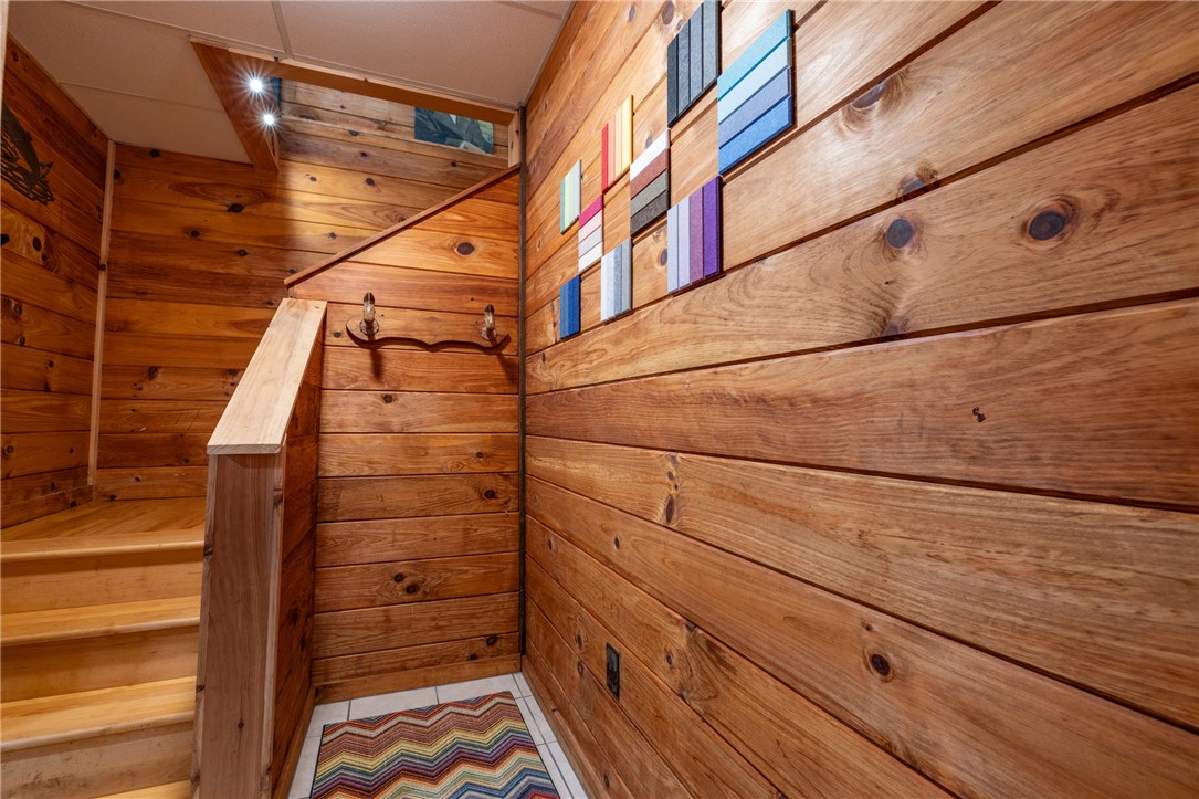 203 Little Lane Seneca, SC 29672 - Photo 26 of 48 This cozy stairway showcases beautiful wood paneling and natural light, creating a warm and inviting atmosphere.