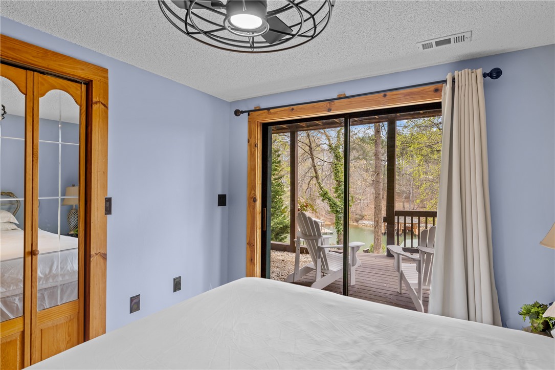 203 Little Lane Seneca, SC 29672 - Photo 30 of 48 This serene bedroom offers direct access to a private deck overlooking tranquil waters.