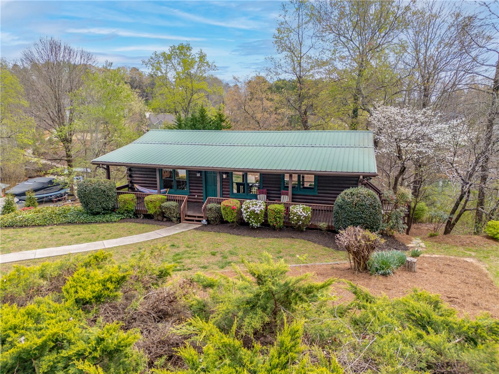 203 Little Lane Seneca, SC 29672 - Photo 3 of 48 This charming retreat offers a serene escape, surrounded by lush greenery and natural beauty.