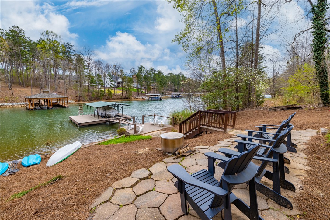203 Little Lane Seneca, SC 29672 - Photo 36 of 48 Relax lakeside on the stone patio, with private dock access and views of the serene water.