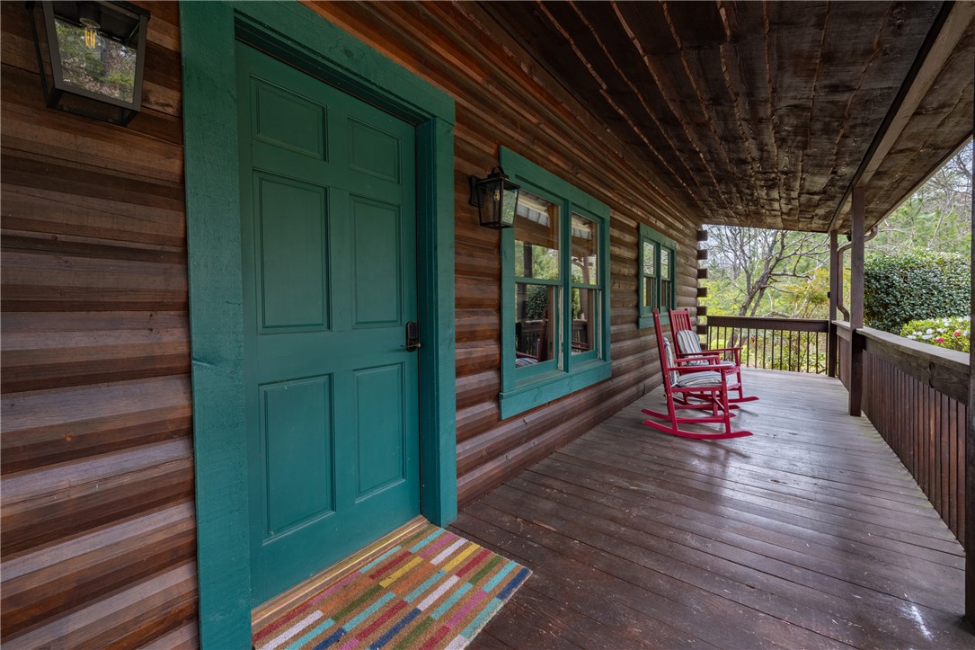 203 Little Lane Seneca, SC 29672 - Photo 5 of 48 Relax on this charming wooden porch, perfect for enjoying peaceful moments outdoors.