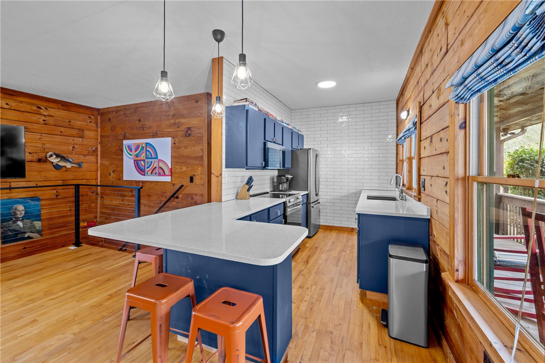 203 Little Lane Seneca, SC 29672 - Photo 8 of 48 This inviting kitchen combines natural wood finishes with modern amenities, creating a warm and functional space.