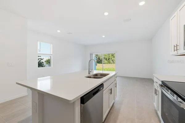 a kitchen that has a sink and a stove in it