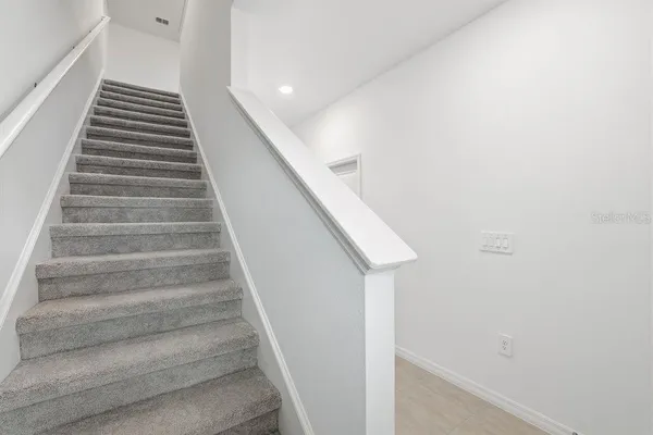 a view of kitchen with refrigerator sink and wooden floor