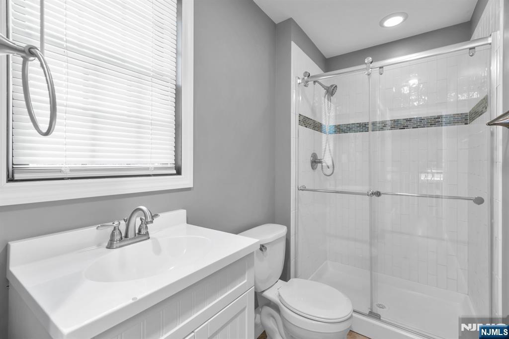 53 Smithfield Road Waldwick, NJ 07463 - Photo 12 of 48 a bathroom with a sink toilet vanity and shower