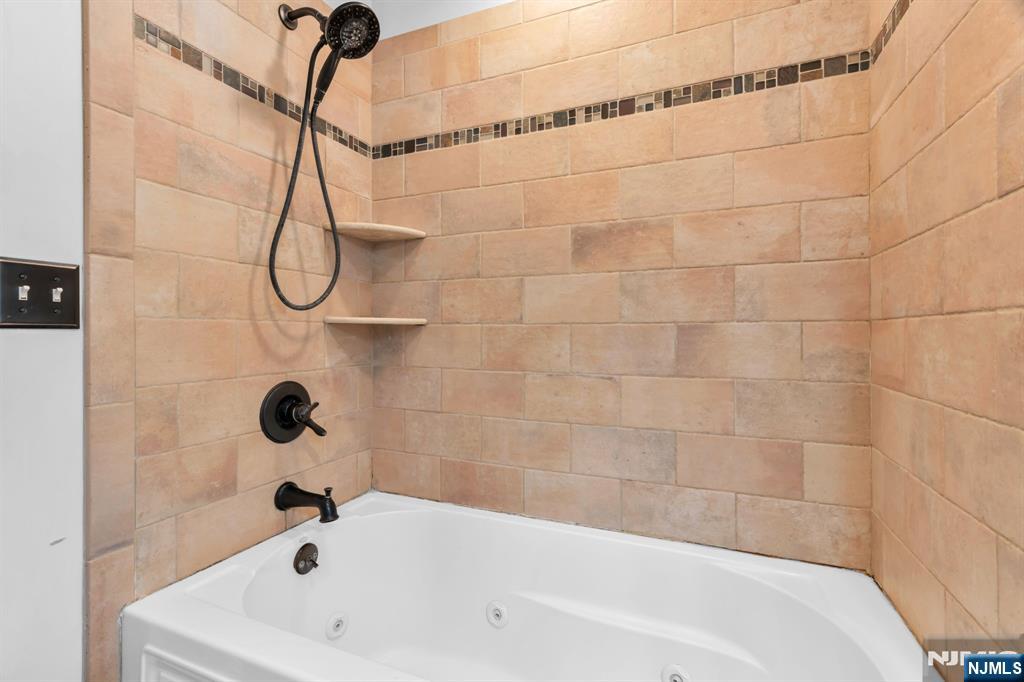 53 Smithfield Road Waldwick, NJ 07463 - Photo 27 of 48 a bathroom with a white bath tub and a shower