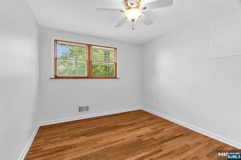 53 Smithfield Road Waldwick, NJ 07463 - Photo 28 of 48 wooden floor in an empty room with a window