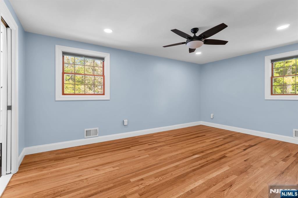 53 Smithfield Road Waldwick, NJ 07463 - Photo 29 of 48 a view of an empty room with a window and wooden floor