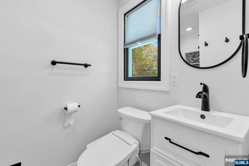 53 Smithfield Road Waldwick, NJ 07463 - Photo 31 of 48 a bathroom with a mirror a sink and a toilet
