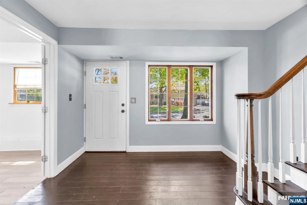 53 Smithfield Road Waldwick, NJ 07463 - Photo 6 of 48 a view of an empty room with wooden floor and a window