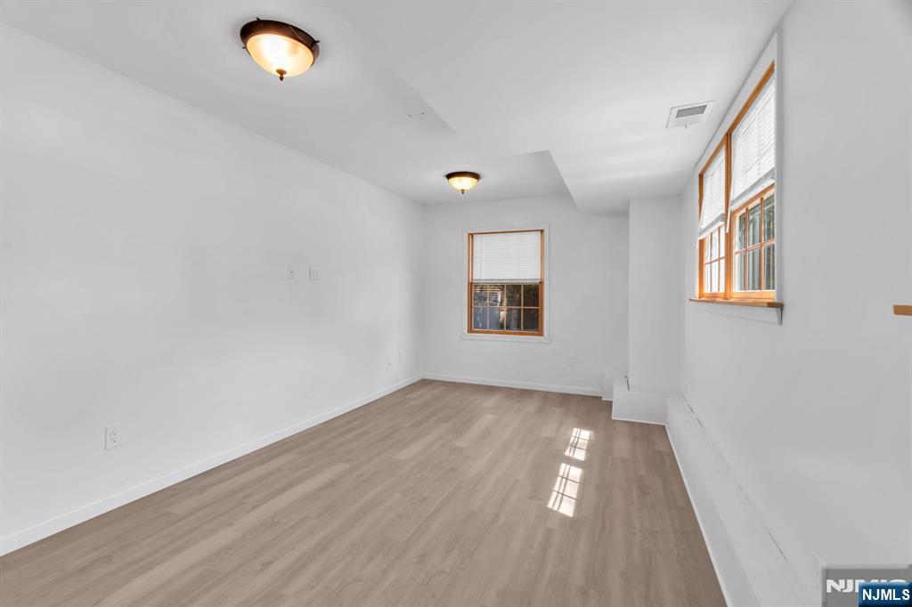 53 Smithfield Road Waldwick, NJ 07463 - Photo 9 of 48 an empty room with wooden floor and windows