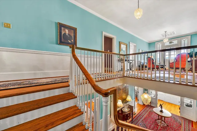 a bedroom with furniture and a large window