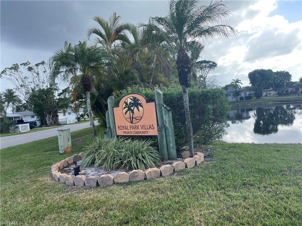 6 Hackney Lane, Unit A26 Naples, FL 34112 - Photo 2 of 24 Community sign featuring a lawn and a water view