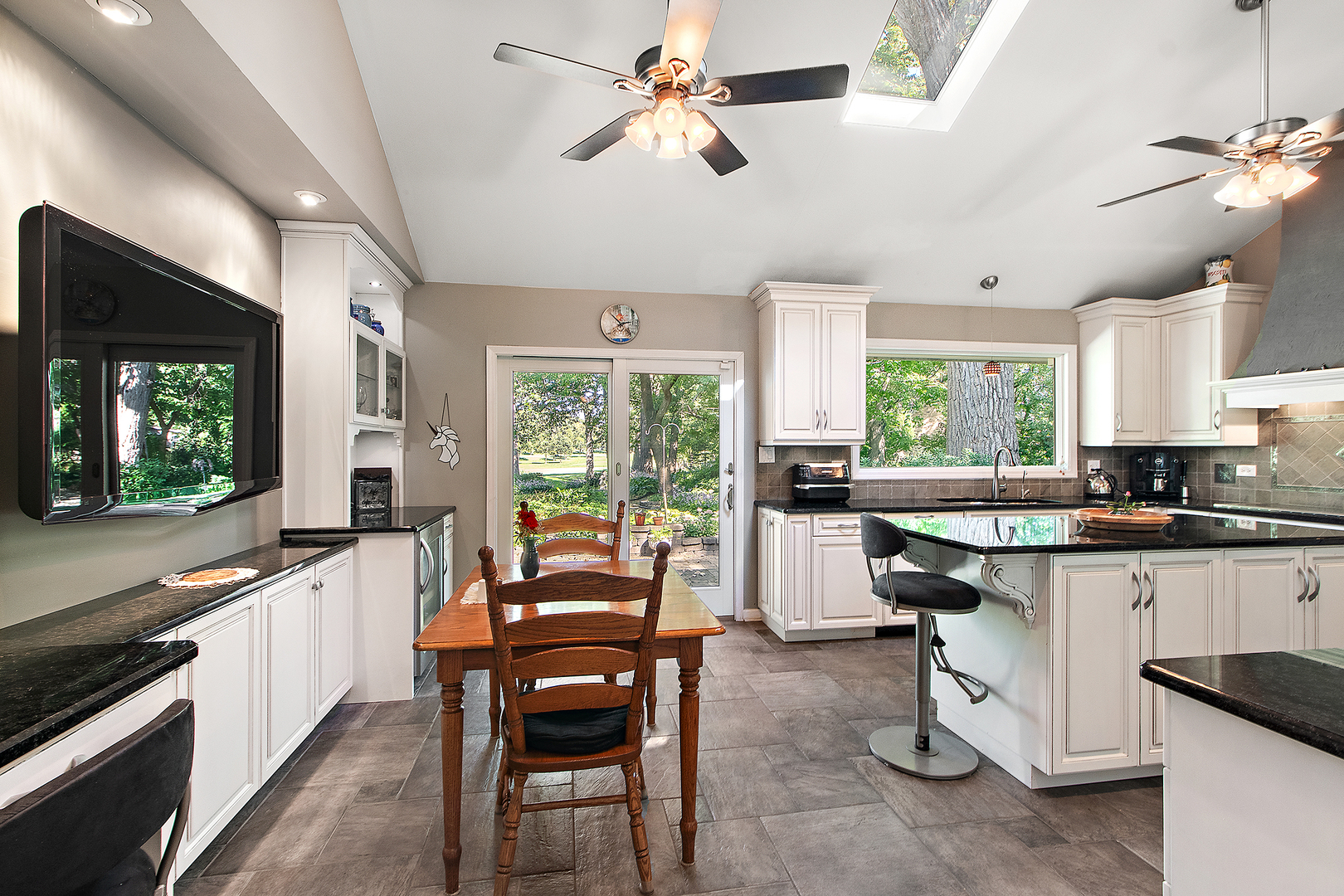 581 Aberdeen Road Frankfort, IL 60423 - Photo 11 of 65 a kitchen with a stove a sink a dining table and chairs