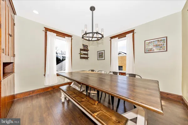a large kitchen with cabinets wooden floor and stainless steel appliances