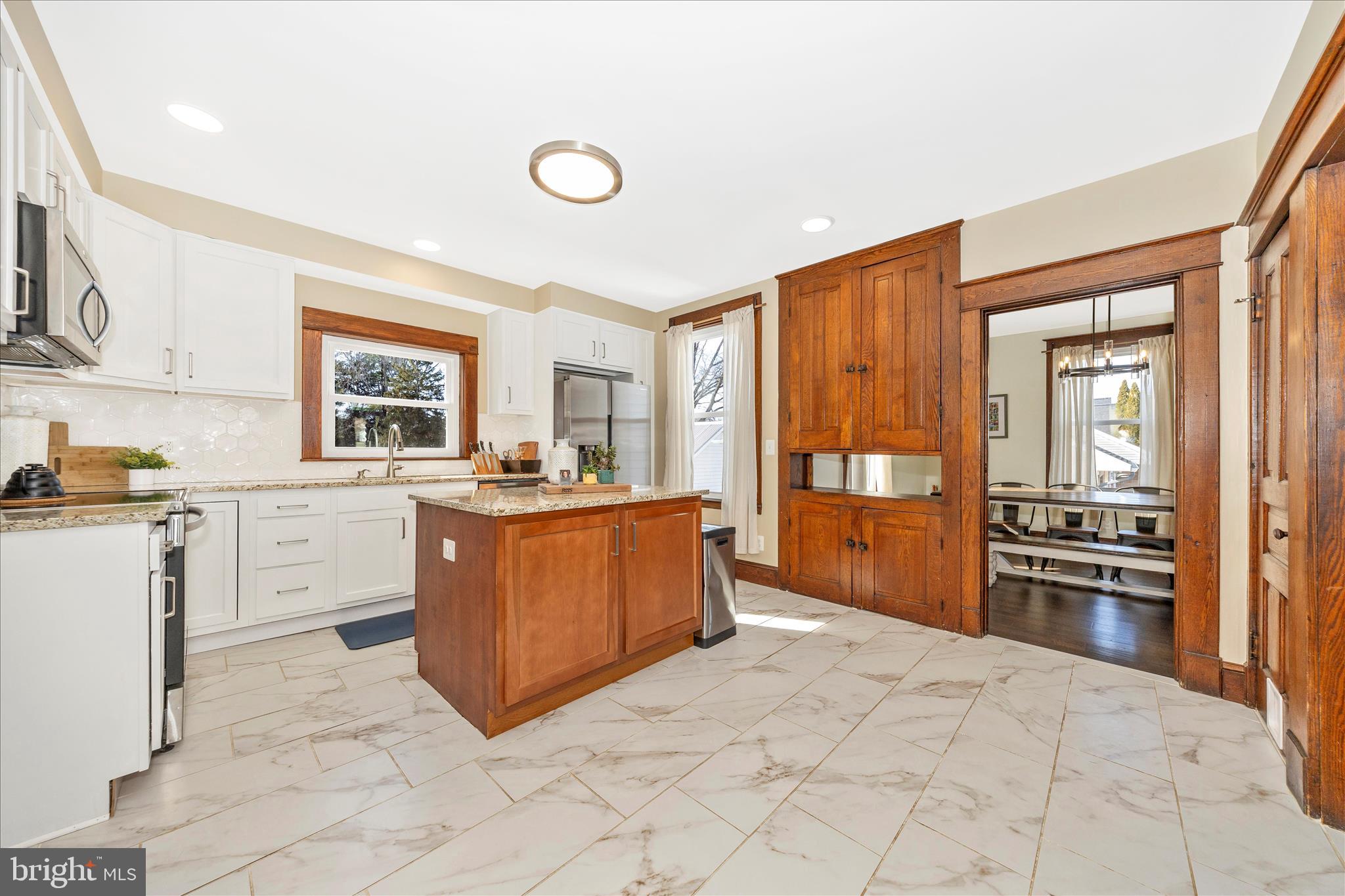 706 East Main Street Middletown, MD 21769 - Photo 15 of 63 a large kitchen with cabinets wooden floor and stainless steel appliances