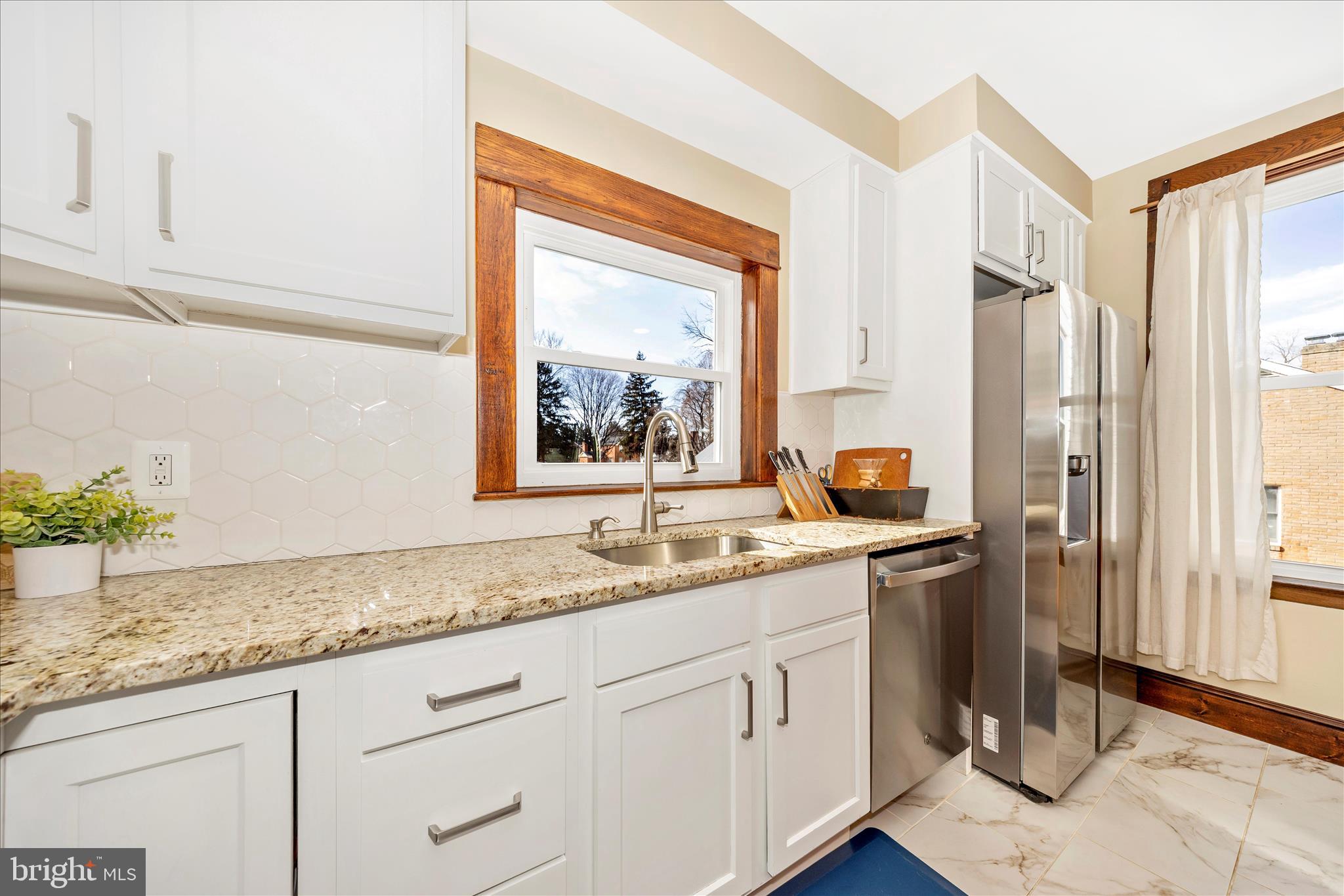 706 East Main Street Middletown, MD 21769 - Photo 18 of 63 a kitchen with a granite countertop sink and refrigerator