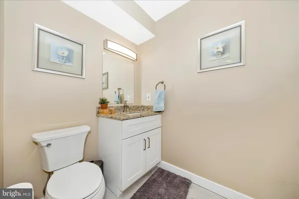 a bathroom with a toilet a sink and a mirror