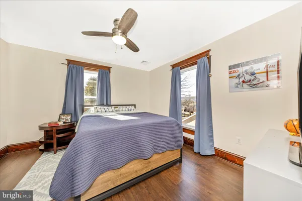 a bedroom with a bed and a large mirror