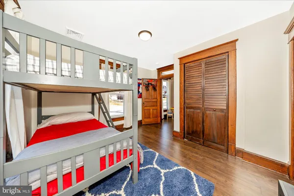 a spacious bedroom with a bed and a cabinets