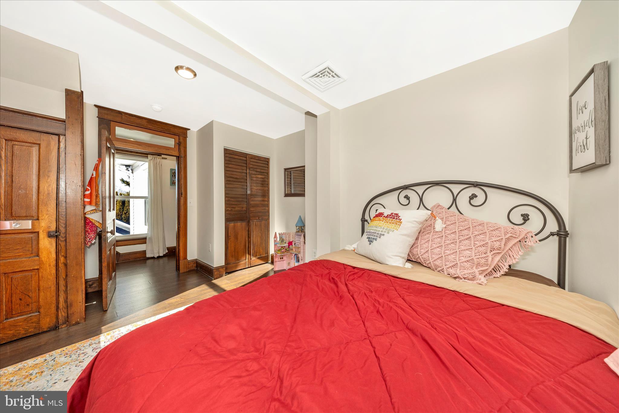 706 East Main Street Middletown, MD 21769 - Photo 30 of 63 a bedroom with a bed and a large mirror