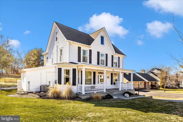 a front view of a house with swimming pool and a yard