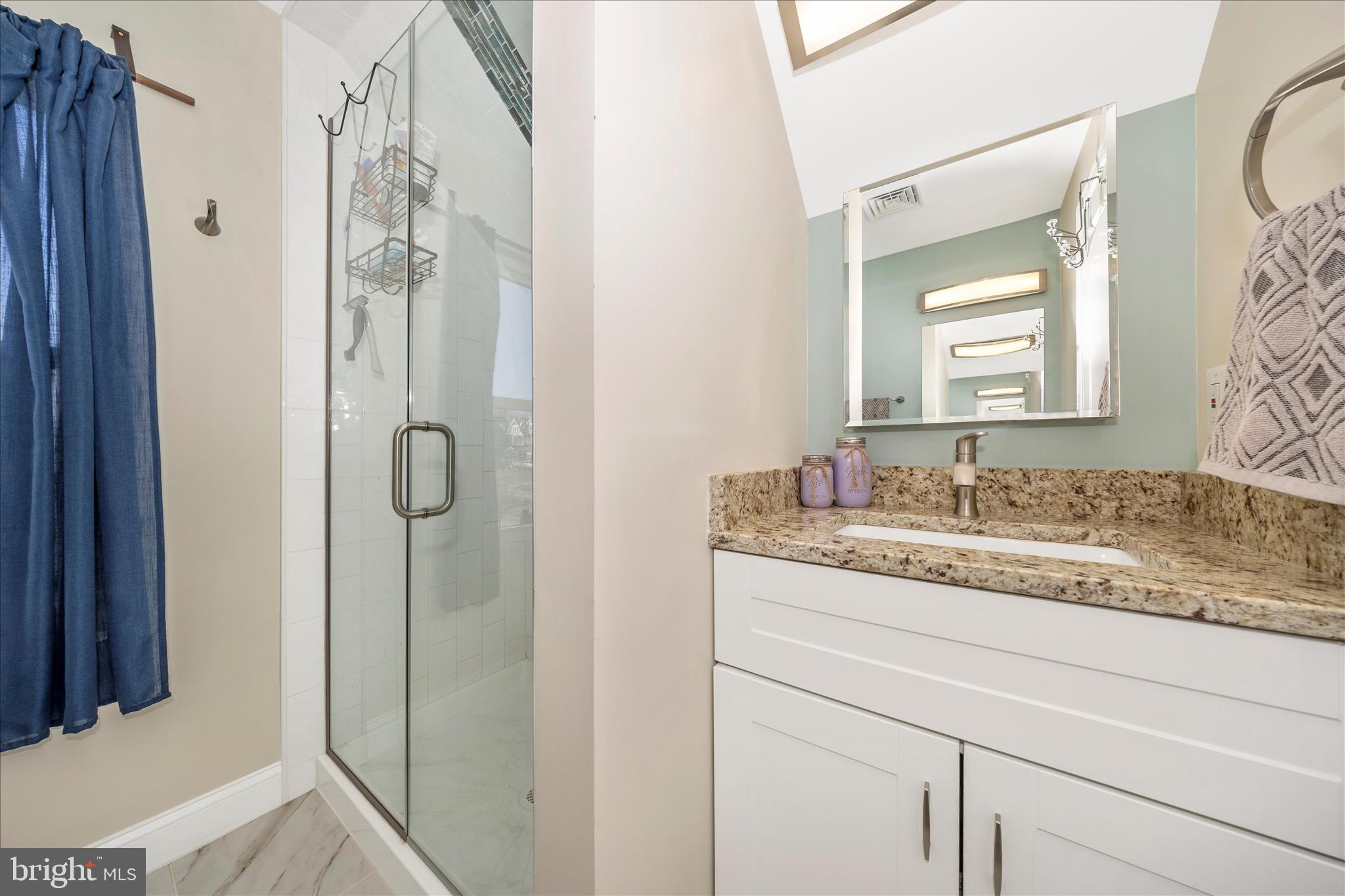 706 East Main Street Middletown, MD 21769 - Photo 37 of 63 a bathroom with a granite countertop sink and a mirror