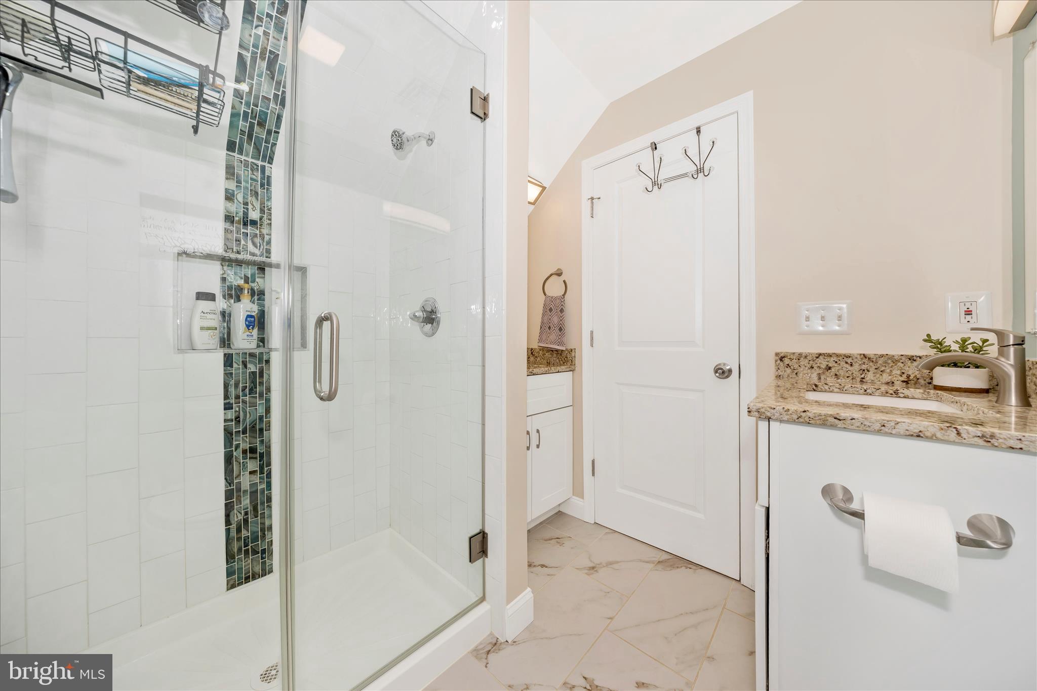 706 East Main Street Middletown, MD 21769 - Photo 38 of 63 a bathroom with a granite countertop shower mirror and a sink