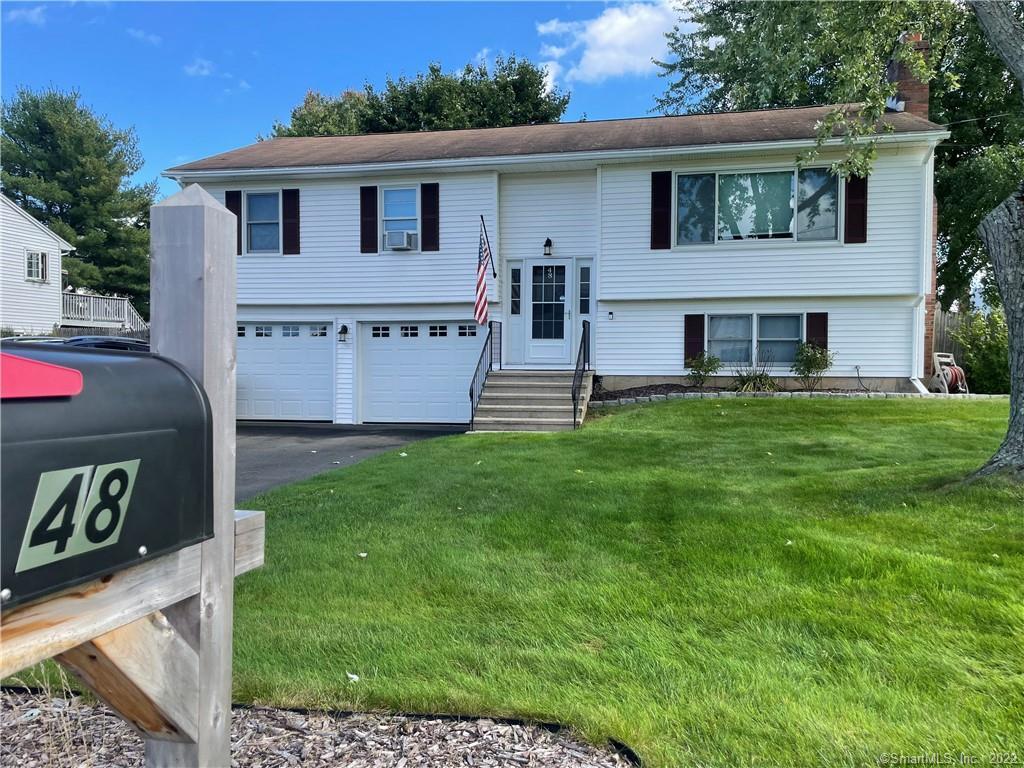 48 Kimberly Drive Enfield, CT 06082 - Photo 1 of 1 a front view of house with yard and outdoor seating