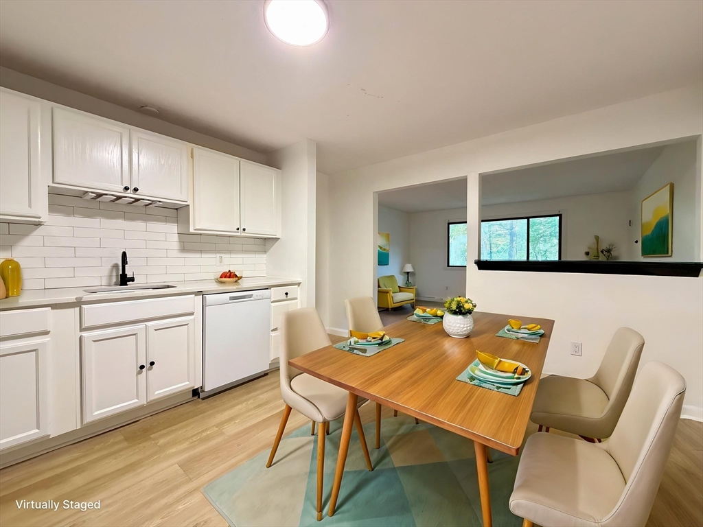 a open kitchen with white cabinets and white appliances