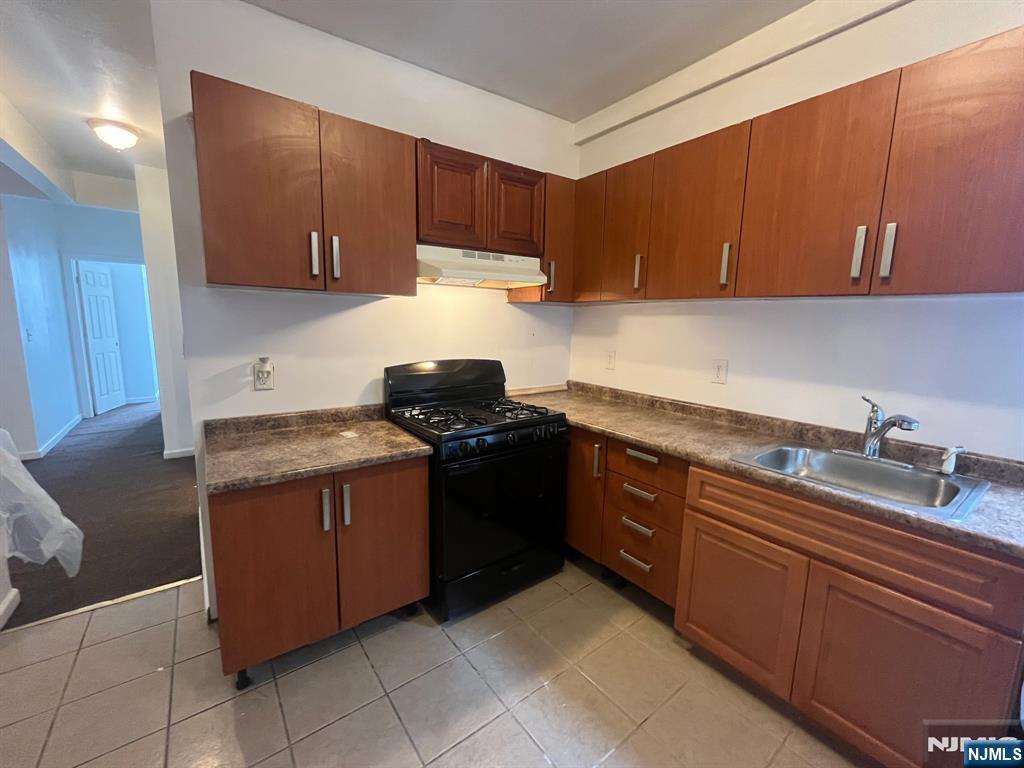 288 South 6th Street, Unit 2 Newark, NJ 07103 - Photo 5 of 5 a kitchen with granite countertop a sink and a stove top oven