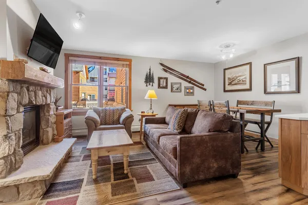 a living room with furniture a flat screen tv and a fireplace