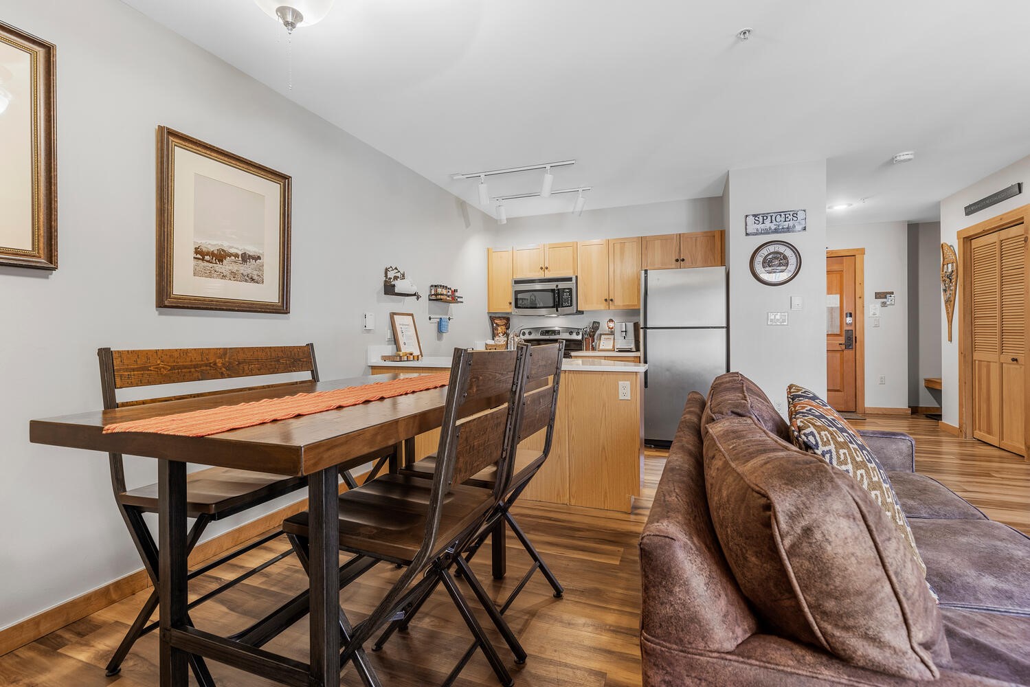 100 Dercum Square, Unit 8337 Keystone, CO 80435 - Photo 9 of 32 a view of a dining room and livingroom with furniture wooden floor a rug and a painting