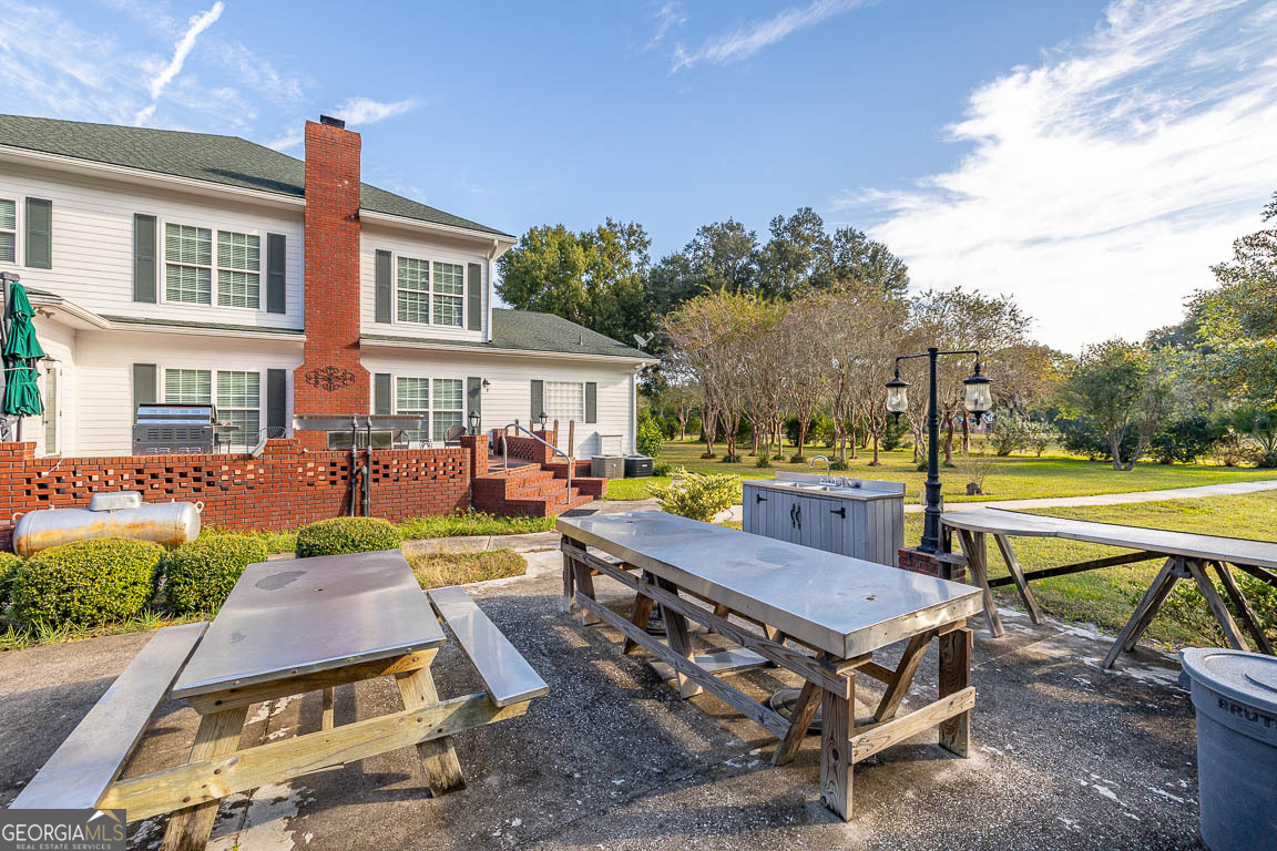 300 Elliott Road Waynesville, GA 31566 - Photo 13 of 89 a view of a swimming pool with lounge chairs in patio